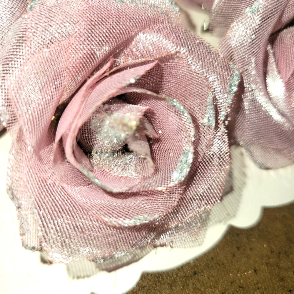 A LOT OF LILACISH COLORED ROSES WITH SILVER TIPS AND ONE GREEN